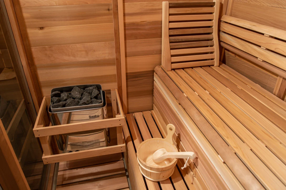 The Pure Cube Indoor Sauna in Red Cedar with tiered bench seating arrangement – at Carr Bank Garden Centre. Pure Cube indoor sauna Red Cedar tiered bench seating – luxury sauna from Carr Bank Garden Centre