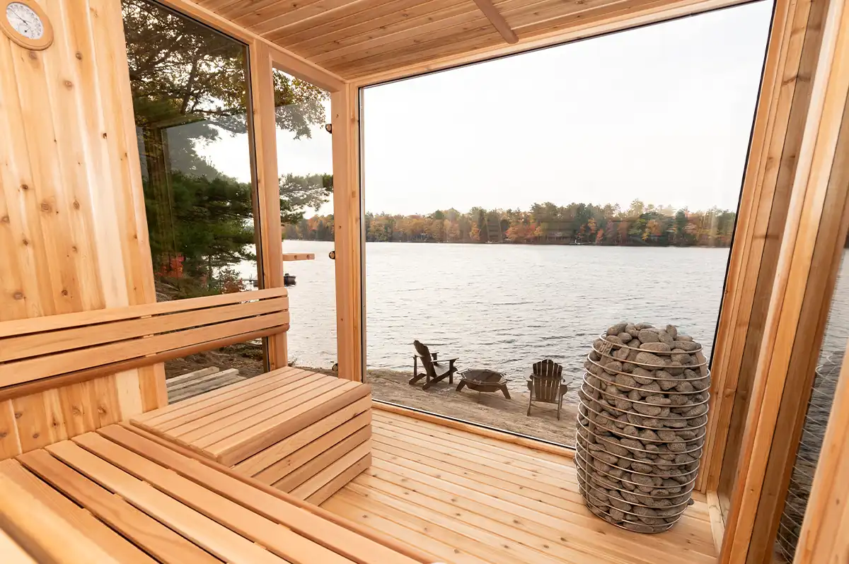 The Pure Cube modern outdoor sauna in Red Cedar in a garden setting – available at Carr Bank Garden Centre. Pure Cube modern outdoor sauna Red Cedar in garden – luxury cube sauna from Carr Bank Garden Centre