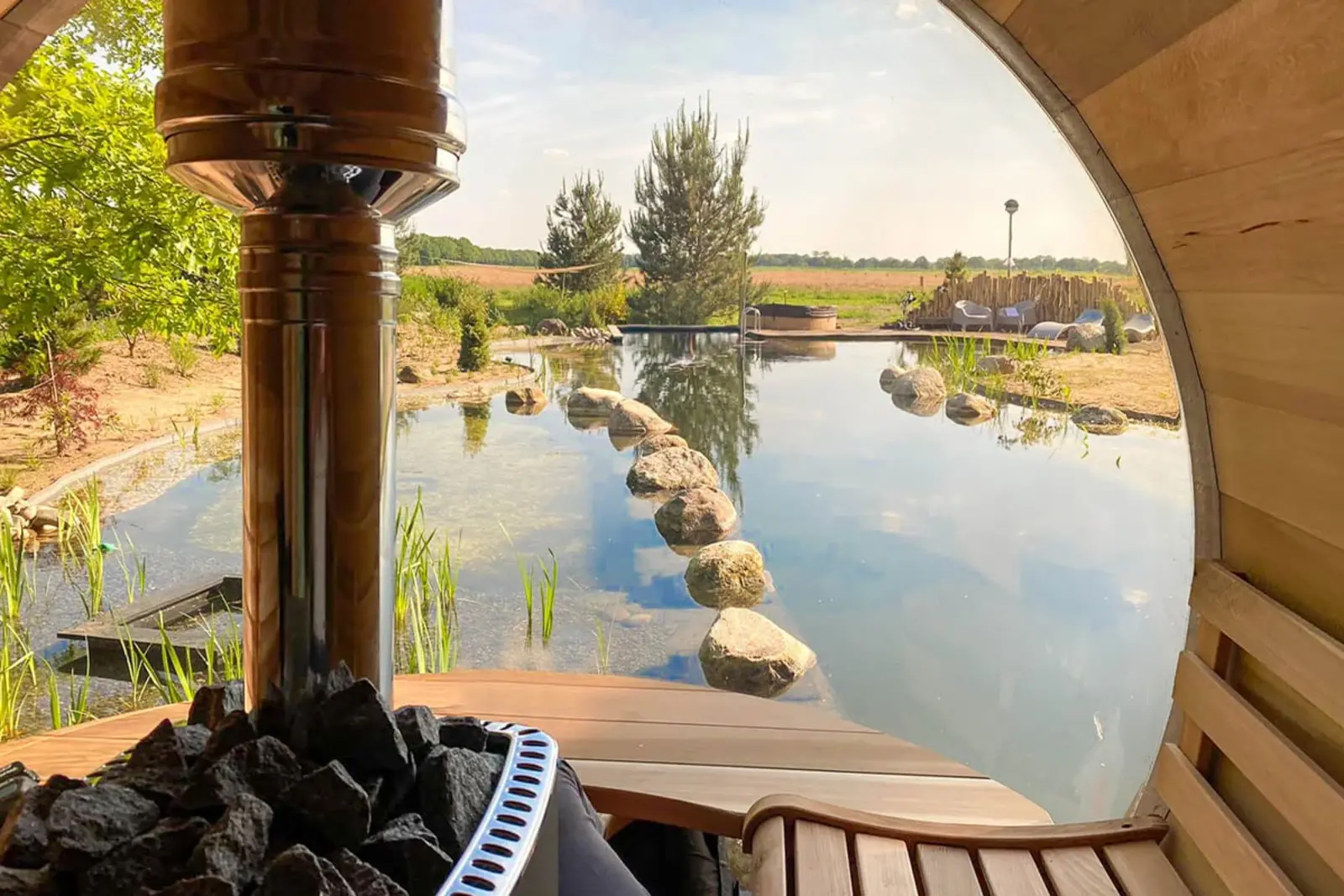 The stunning panoramic window view from inside the Panorama Cedar Barrel Sauna – available at Carr Bank Garden Centre. Panorama Cedar Barrel Sauna interior panoramic view through window – luxury garden sauna Carr Bank