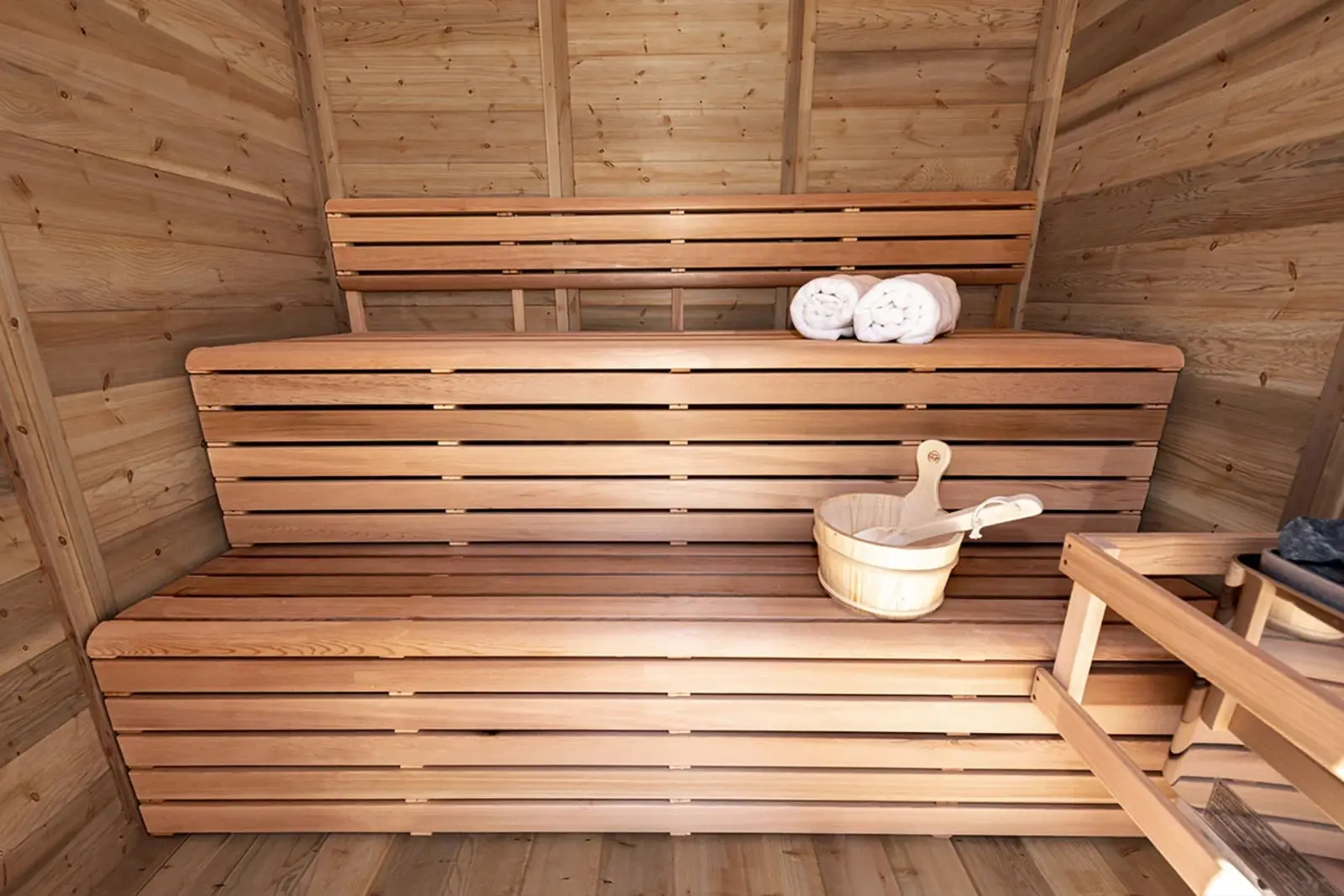 The Pure Cube Sauna interior showing the tiered bench layout – available at Carr Bank Garden Centre, Cumbria. Pure Cube Sauna interior with tiered benches – outdoor garden sauna from Carr Bank Garden Centre